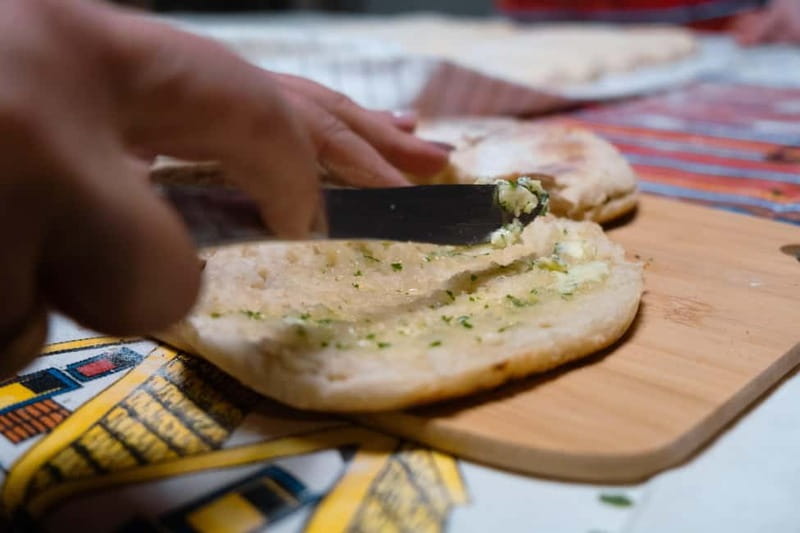 Madeira: Bolo do Caco Workshop with a Local Family - The table: garlic butter, cheese, chouriço, and fruit